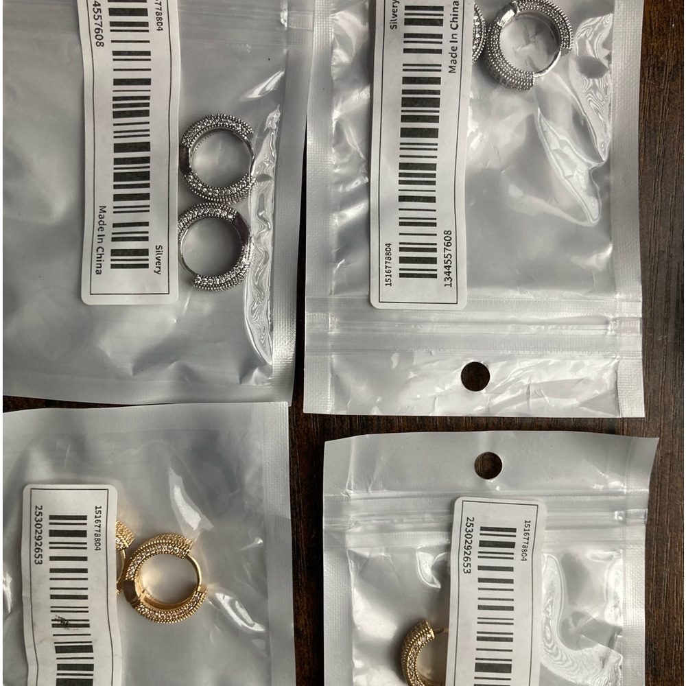 Hoop earrings.  Two sets of gold and silver colored with cz’s
